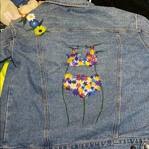 Jean jacket has a painting on the back